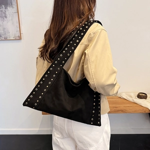 Chic black velvet underarm bag with gold metal rivets and minimalist silhouette