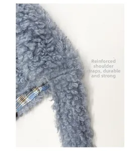 Detail showing reinforced shoulder strap on light blue teddy fabric shoulder bag