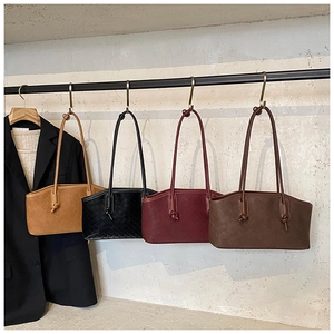 Detail of woven shoulder bags in four colors with knot accents and chic retro styling