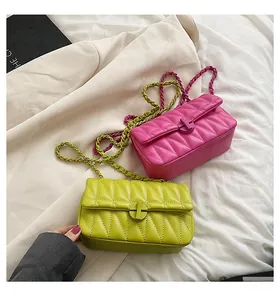 Detailed shot of quilted chain bags in vibrant fuchsia and bright lime green colors