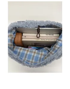 Internal view of plush tote bag showing blue plaid lining and large storage capacity