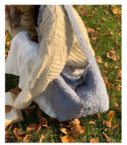 Detailed texture of soft light blue fleece tote bag with brown drawstring closure