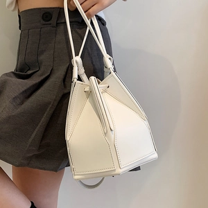 White geometric folding bucket bag with triangle panels and drawstring closure