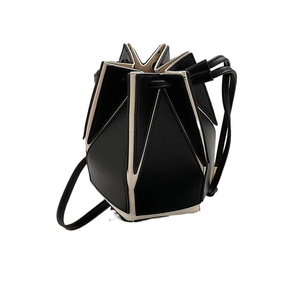 Foldable geometric bucket bag with black and white contrast leather and drawstring strap