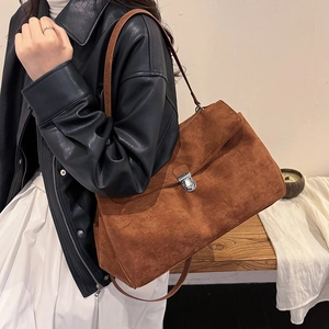 Retro caramel brown suede shoulder bag with minimalist flap and metallic buckle