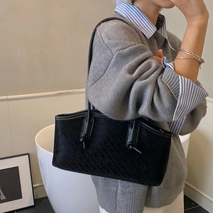 Black woven leather tote bag with stylish knot strap for chic women daily commute