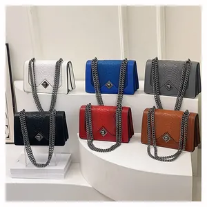 Selection of faux snake skin chain bags in various colors including blue and red