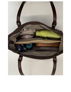 Interior view of large tote bag showing stripe lining and organized compartments
