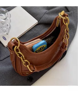 Brown hobo shoulder bag with gold chain showing spacious interior for daily essentials