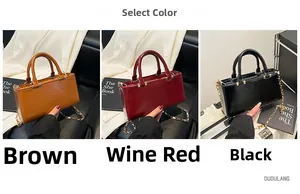 Close-up of elegant leather tote bags in brown, burgundy, and black with gold chain straps