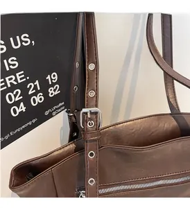 Close-up of vintage brown leather bag with silver metal buckle and oil-wax texture details