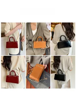 Three minimalist tote bags in burgundy, tan and black with gold chain straps and handles