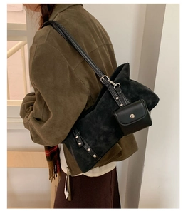 Detail of black suede tote bag with silver studs and detachable small coin purse