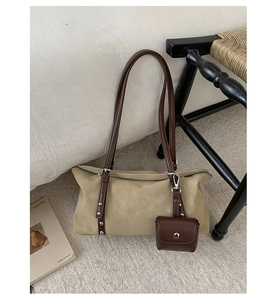 Detail of beige tote bag with dark brown rivet strap and mini square coin purse