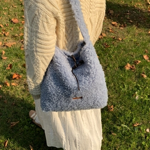 Chic light blue faux shearling tote bag with drawstring closure for autumn and winter
