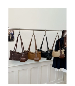 Detail view of large tote bags in matte leather with matching mini coin pouches attached