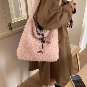 Chic pink fuzzy faux shearling tote bag with drawstring closure and shoulder straps