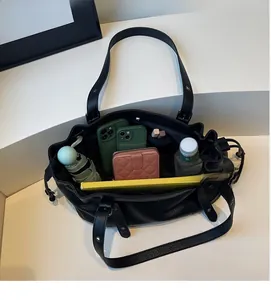 Spacious interior of black pebble leather tote bag showing ample storage for daily essentials