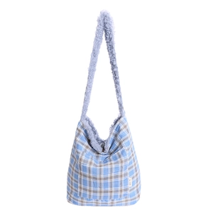 Blue plaid hobo bag with plush lamb wool lining and front pocket for winter fashion