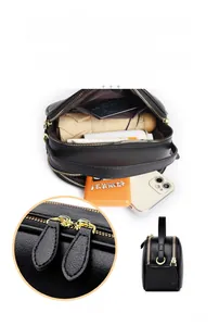 Internal view showing large capacity and multi-compartment design of the black leather bag