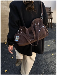 Detail of dark brown matte tote bag with silver metal ring and hanging card holder