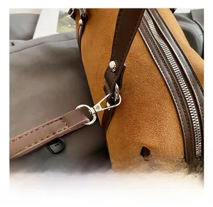 Close-up of premium silver metal hooks and brown suede texture on Boston bag
