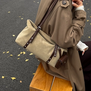 Retro beige suede Boston bag with brown leather straps and silver studs in autumn setting
