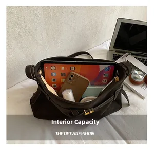 Detail view of large brown tote bag interior with iPad and daily essentials