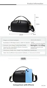 Detail view of black lychee grain leather handbag with dimensions 22x13x9cm and strap