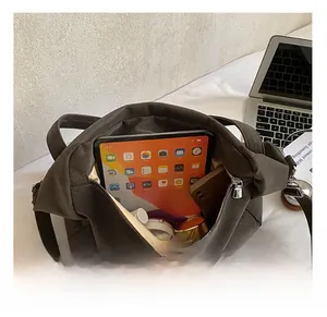 Close-up of spacious inner compartment with gold lining and metal zipper closure