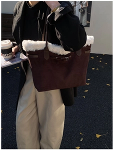 Brown suede tote bag with white faux fur trim and leather buckle straps for winter