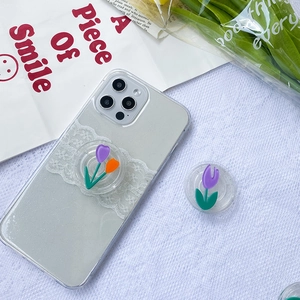 Detail of translucent glitter phone case with floral lace and tulip socket stand