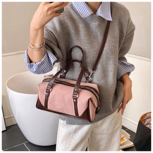 Pink and brown two-tone Boston bag shown on a model for style and size reference
