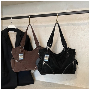 Close-up of large matte tote bags with side zipper pockets and cute cartoon charms