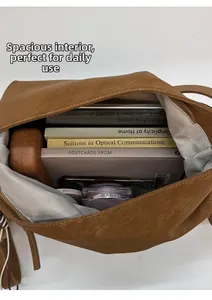 Spacious interior of brown pebbled leather tote showing ample room for books and essentials