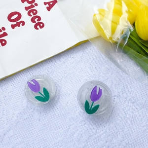 Macro shot of clear floral phone sockets with purple tulips on white textured fabric