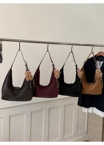 Hobo bag collection showing matte texture, zipper closure and plush bear charm detail