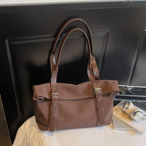 Minimalist large brown commuter tote bag with shoulder straps and buckle detail