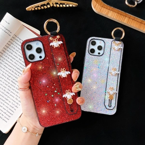 Detail of glitter iPhone case with sparkling rhinestones, pearl bee and ring handle