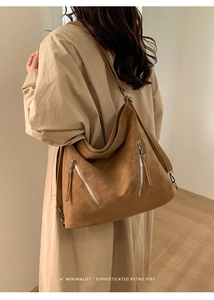 Detail view of large caramel suede hobo bag with stylish silver zipper accents