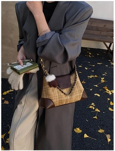 Detail of vintage plaid dumplings bag with leather trim and winter glove charm