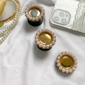 Detailed view of pearl-embellished glitter phone sockets in gold and silver finish