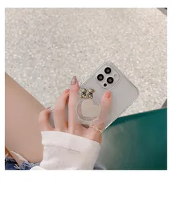 Detail of glitter phone case for iPhone with heart socket and golden bear charms