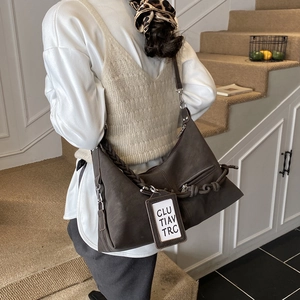 Winter dark coffee crossbody dumpling bag with textured matte finish and woven strap