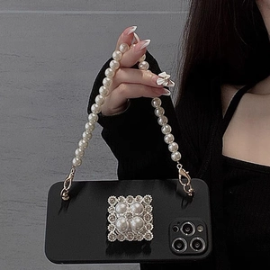 Matte black iPhone case featuring a pearl square center ornament and luxury pearl handle