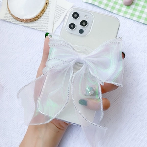 Macro detail of the 3D white organza lace bow phone stand with silver stitching texture