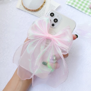 Detailed close-up of pink organza ribbon bow on a clear phone case with pearlescent finish