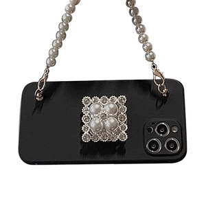 Black iPhone case featuring pearl hand strap and luxury rhinestone square folding stand