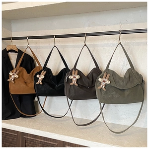 Detail view of four matte tote bags in brown, black, coffee and green with rabbit charms
