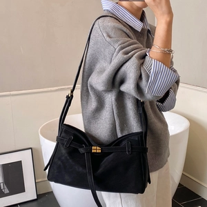 Minimalist black matte leather tote bag with gold buckle for women in daily office use